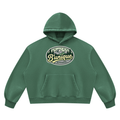 Green ODMPOD Unisex UNIQUE MOUTAIN Vintage Wash Boxy Fleece Hoodie featuring a front kangaroo pocket and a circular chest graphic of mountains, pine trees, and the text Bunique APPAREL.