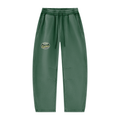 ODMPOD Unisex UNIQUE MOUNTAIN Vintage Wash sweatpants in dark green, featuring an elastic waistband, drawstring, and a mountain graphic patch on the upper left leg.
