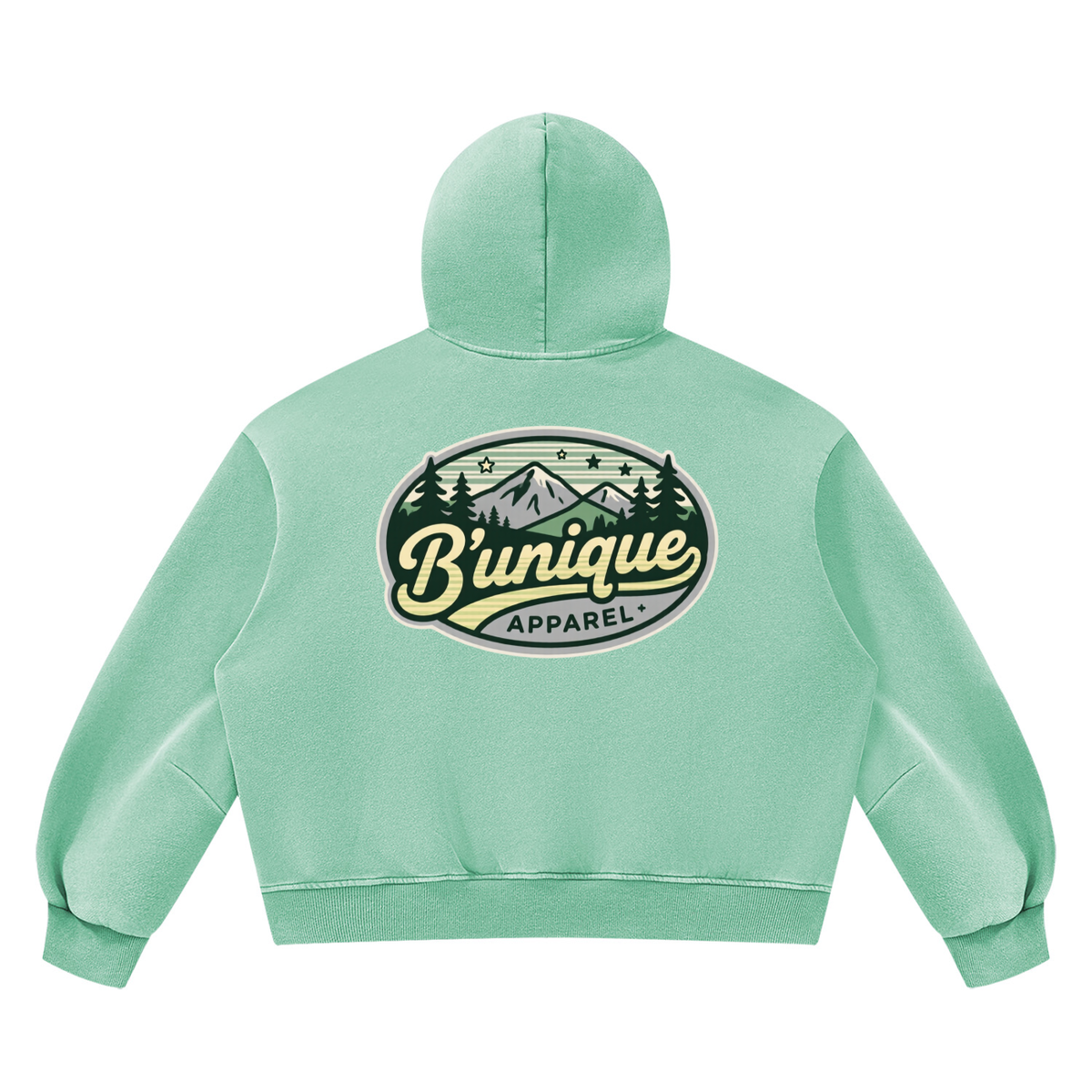 Back view of a light green Unisex UNIQUE MOUTAIN Vintage Wash Boxy Fleece Hoodie featuring a mountain landscape graphic with the text Bunique Apparel in an oval frame.
